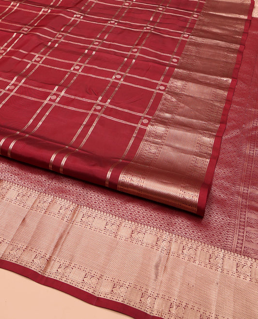 Maroon Vasundhara Silk Saree, Artfully Detailed with Buttas and Checked Design on Its Body, Highlighted by Zari Border of Manga Mokku, Poun, Mayil, and Mayil Kann Designs, Pallu of Geometric Designs, and Paired with a Matching Blouse