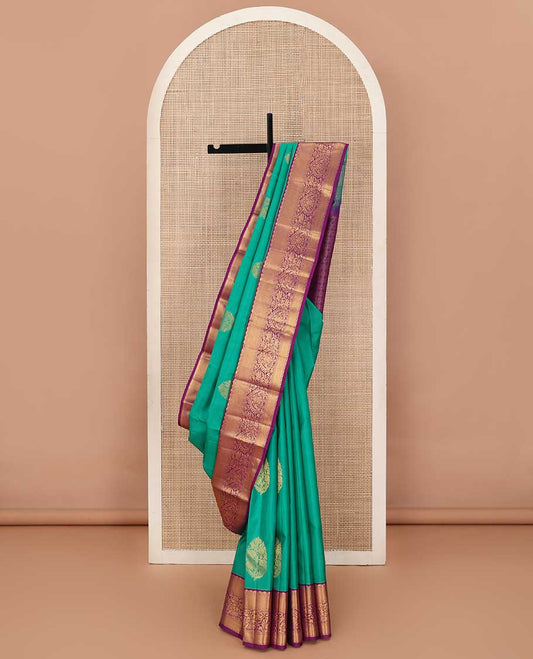 Turquoise blue zari buttas silk saree, contrast border of traditional zari designs, and jaal pallu