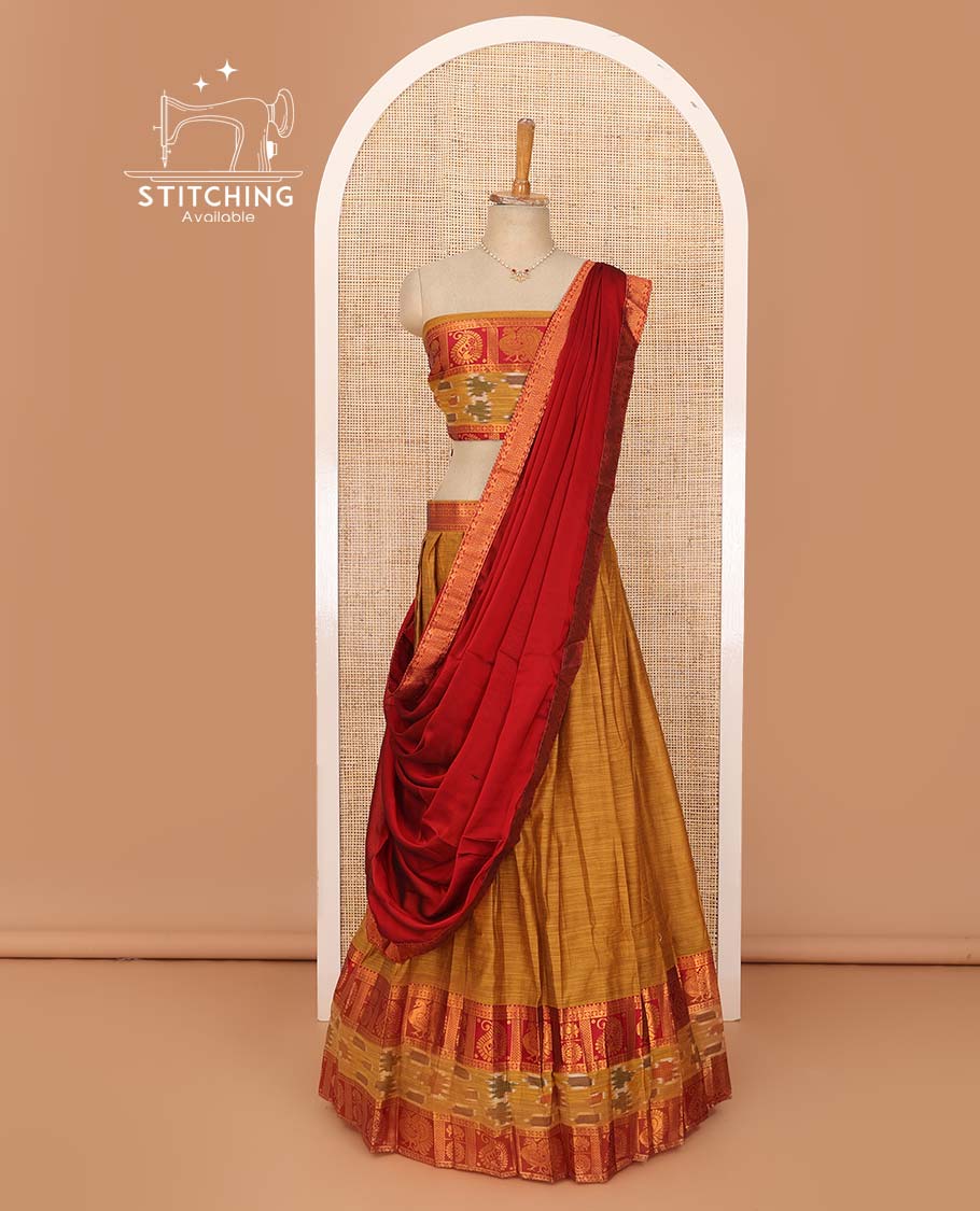 Mustard lehenga set, contrast traditional zari, and ikkat border skirt, matching blouse, and contrast zari bordered plain dhavani