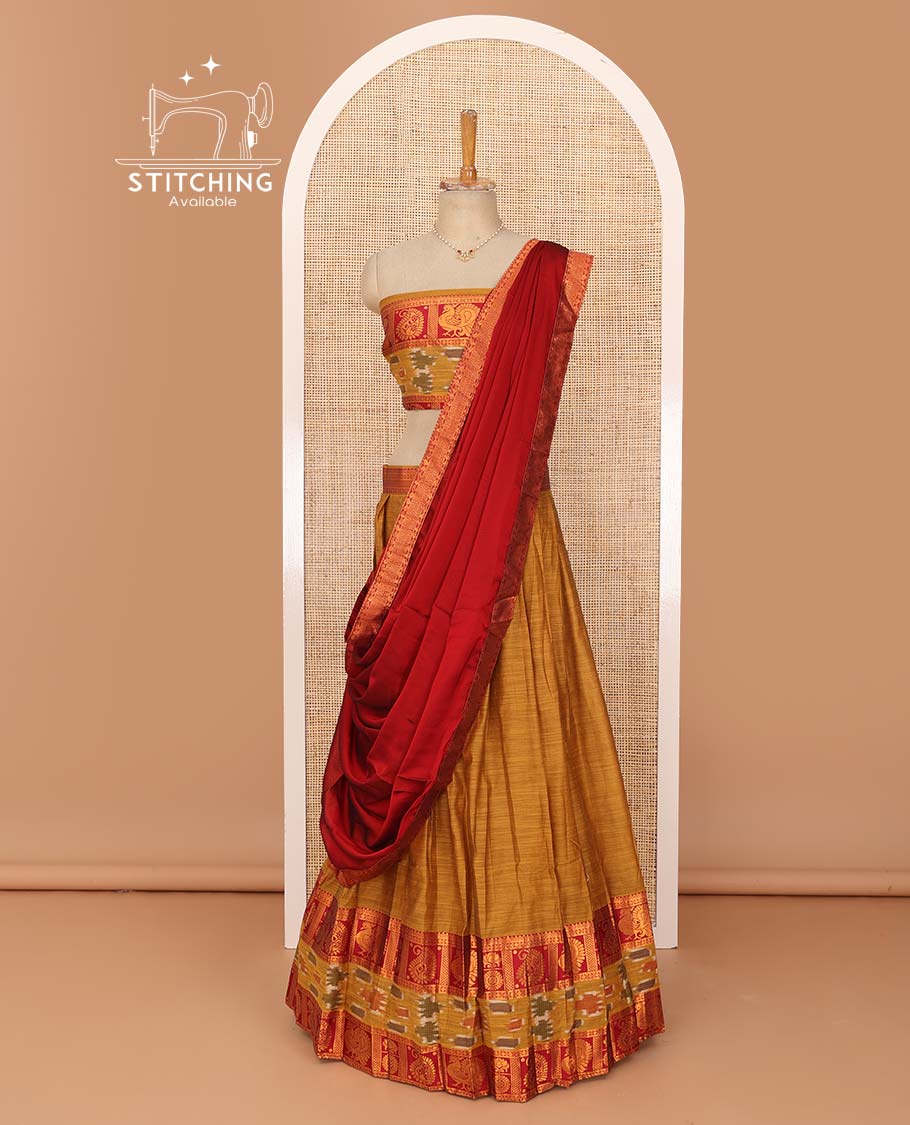 Mustard lehenga set, contrast traditional zari, and ikkat border skirt, matching blouse, and contrast zari bordered plain dhavani