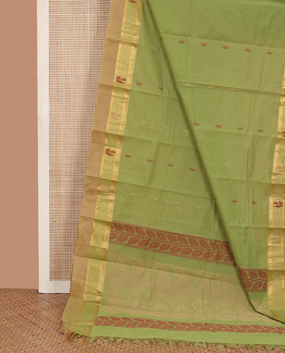 Parrot green buttas kanchi cotton saree, contrast thread and zari paisley border, and pallu of chevron and leaf motifs