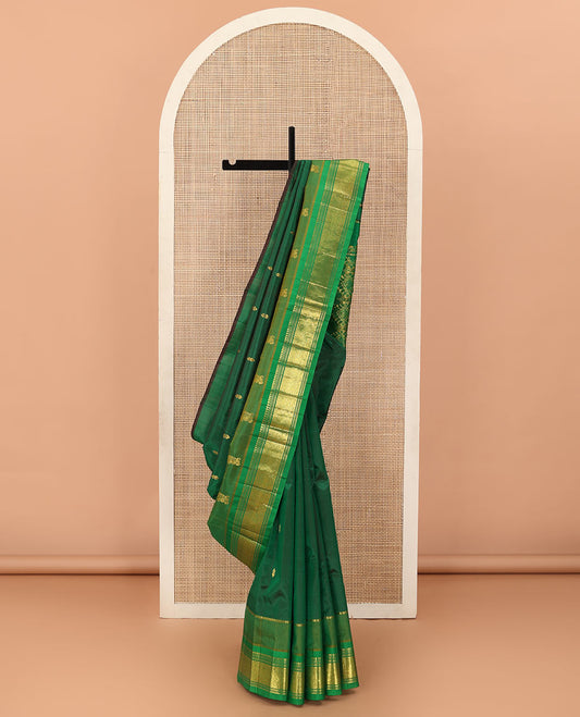 Green zari buttas Kanchipuram silk saree, contrast one-sided border of paneer sombu, banaras, muthu, and jaal designs, and floral-geometric pallu