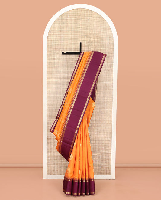 Orange Vasundhara Silk Saree, Delicately Woven with Zari Buttas All Over Its Body, Complemented by a Contrast Rettai Pettu Temple Border of Zari Designs, Grand Jaal Pallu, and Paired with a Contrast Blouse