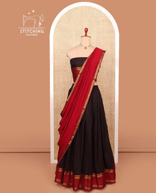Black checked cotton half-saree with contrast traditional zari bordered skirt, a matching blouse, and a contrast traditional bordered dhavani