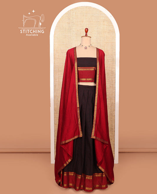 Black checked cotton half-saree with contrast traditional zari bordered skirt, a matching blouse, and a contrast traditional bordered dhavani