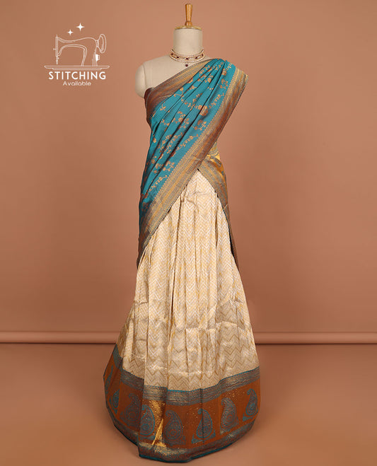 Cream geometric design half saree with contrast zari border, zari design blouse & blue floral zari design dhavani