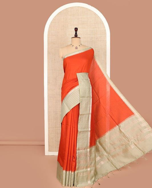 Sandal Plain Assam Silk Saree, Complemented by a Contrast Traditional Zari Design Border, Pallu Steeped with Zari Stripes, and Paired with a Contrast Blouse