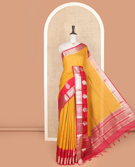 Yellow micro-checked assam silk saree, contrast traditional zari border of paisley designs, and zari striped pallu