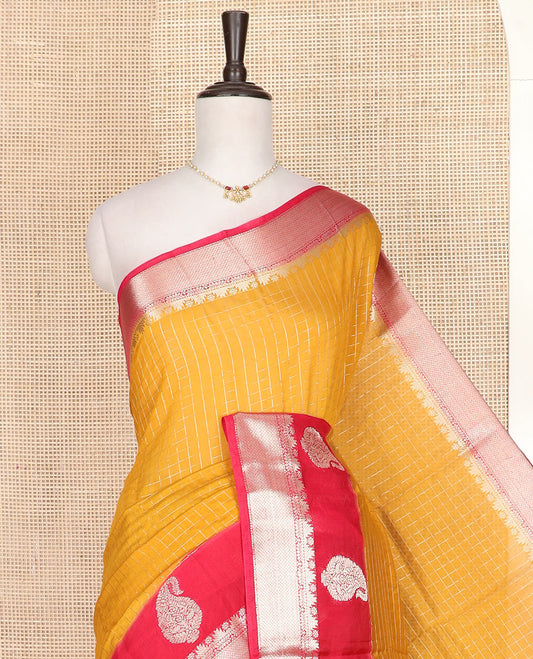 Yellow micro-checked assam silk saree, contrast traditional zari border of paisley designs, and zari striped pallu