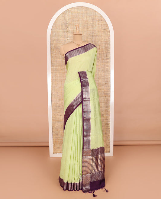 Green Assam Silk Saree Features Sparsely Woven Buttas, Complemented by Contrast Traditional Zari Design Border, Pallu Elevated with Zari Stripes, and Paired with a Contrast Blouse