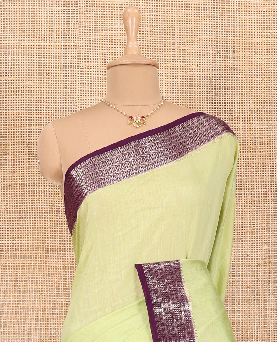 Green Assam Silk Saree Features Sparsely Woven Buttas, Complemented by Contrast Traditional Zari Design Border, Pallu Elevated with Zari Stripes, and Paired with a Contrast Blouse