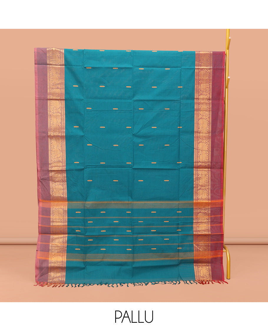 Blue Chettinad Cotton Saree, Bedecked with Thread Buttas All Over Its Body, Complemented by a Contrast Ganga-Jamuna Kal Eragina Border of Kodi Peacock and Elephant Designs, Pallu of Buttas and Stripes, and Paired with a Matching Blouse