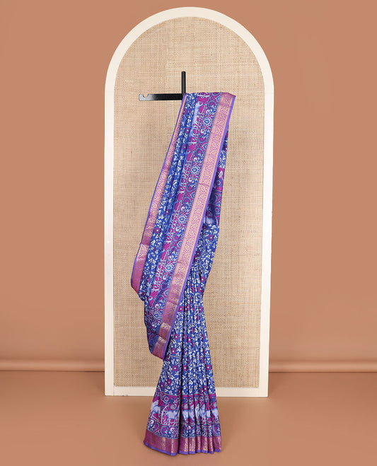 Royal blue floral vine patola silk saree, contrast traditional zari border and pallu of Pichwai cow and peacock motifs