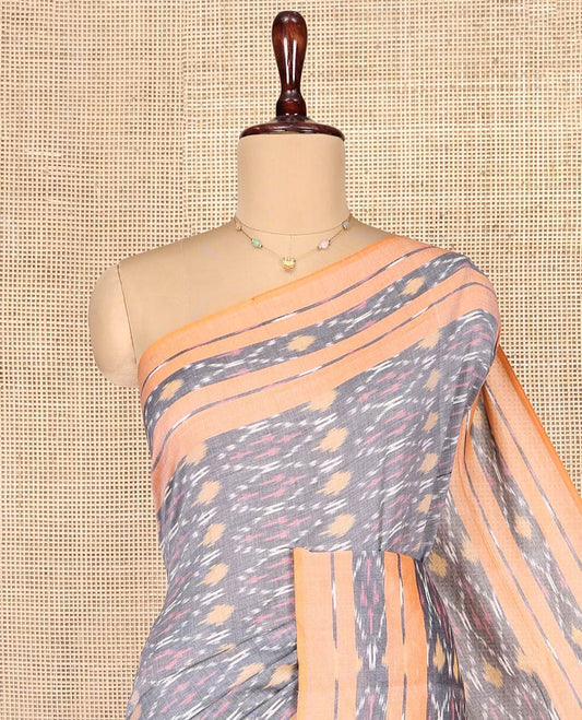 Grey Ikkat Cotton Saree, Decorated with Ikkat-Style Ogee Patterns on Its Body, Complemented by Contrast Ikkat-Textured Border, Pallu Steeped with Ikkat Buttas, and Has No Blouse