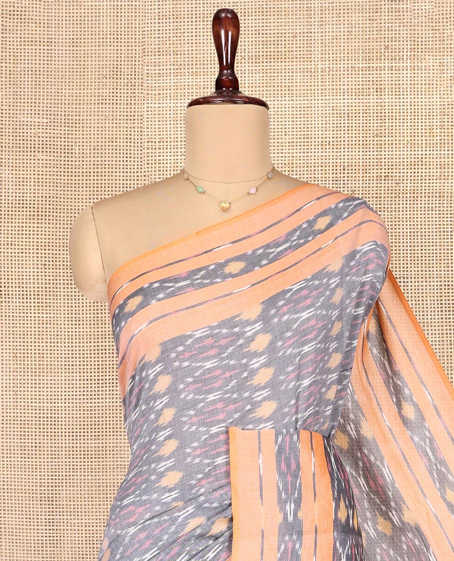 Grey Ikkat Cotton Saree, Decorated with Ikkat-Style Ogee Patterns on Its Body, Complemented by Contrast Ikkat-Textured Border, Pallu Steeped with Ikkat Buttas, and Has No Blouse