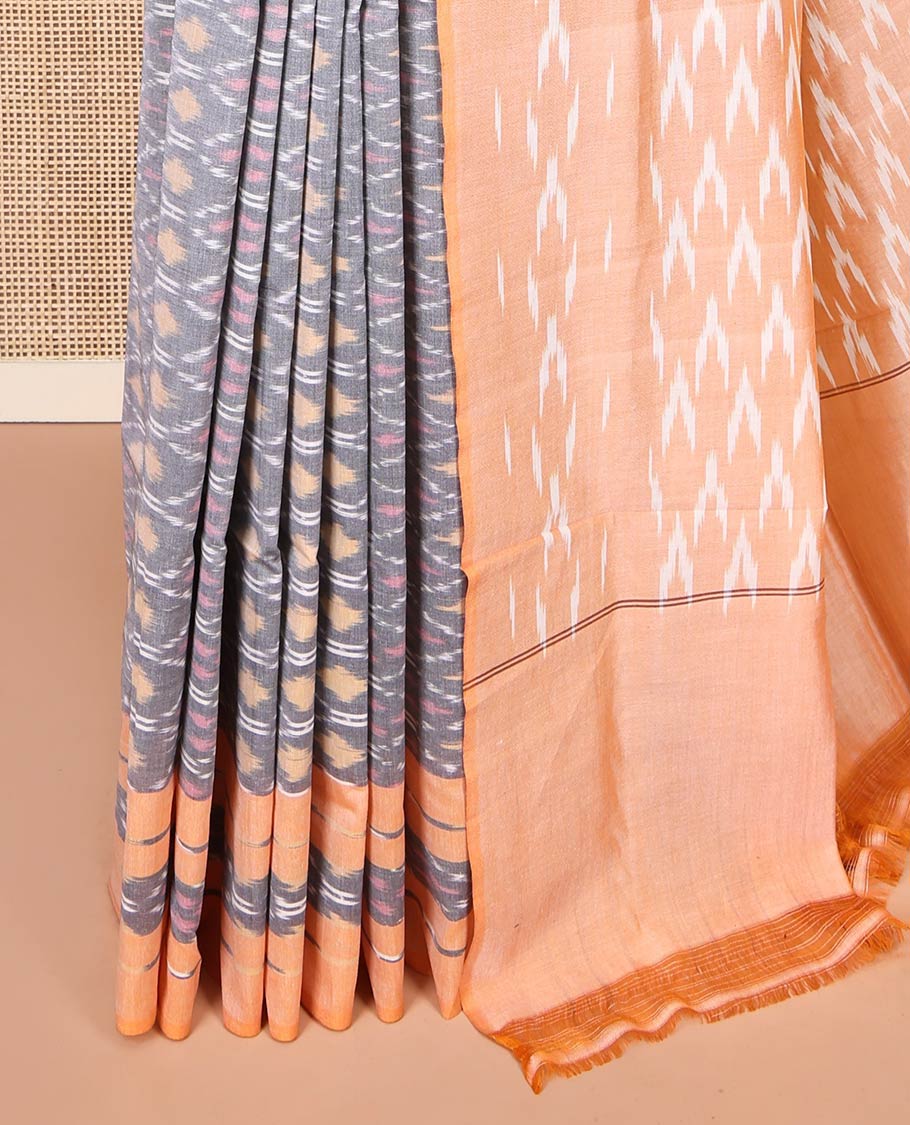 Grey Ikkat Cotton Saree, Decorated with Ikkat-Style Ogee Patterns on Its Body, Complemented by Contrast Ikkat-Textured Border, Pallu Steeped with Ikkat Buttas, and Has No Blouse