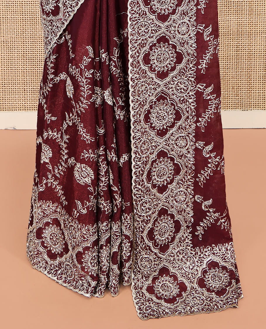 Wine Designer Saree, Decked Up with Floral Embroidered All Over Its Body, a Scallop Embroidered Border, and Matching Blouse