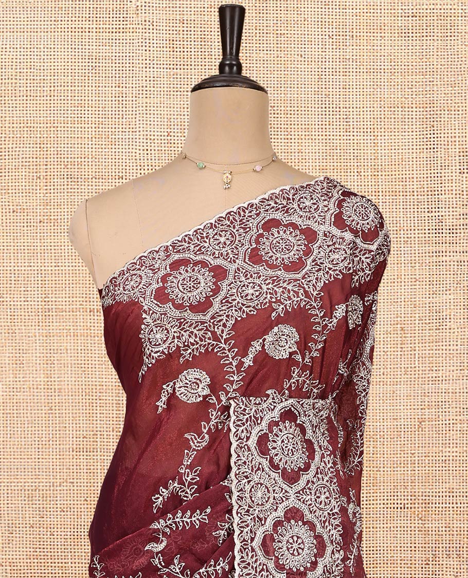 Wine Designer Saree, Decked Up with Floral Embroidered All Over Its Body, a Scallop Embroidered Border, and Matching Blouse