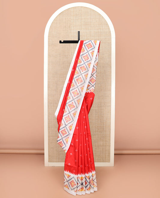 Red Ikkat Silk Saree with Ikkat Buttas, Accentuated with a Contrast Ikkat Jaal-Patterned Border, Pallu Features Ikkat Jaal Patterns, and with a Contrast Blouse