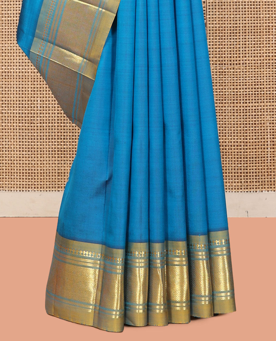Blue Kanchipuram Silk Saree, Gleamed Up with Zari Buttas, a Contrast One-Sided Border of Panner Sombu, Banaras, and Jaal Designs, a Zari Design Pallu, and No Blouse