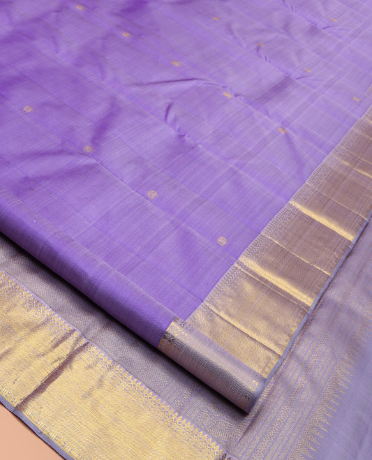 Lavender Kanchipuram Silk Saree, Ornamented with Zari Buttas All Over Its Body, Highlighted by Zari Border of Thilakam Mokku, Poun, and Kathir Designs, Gleaming Pallu, and Paired with a Matching Blouse