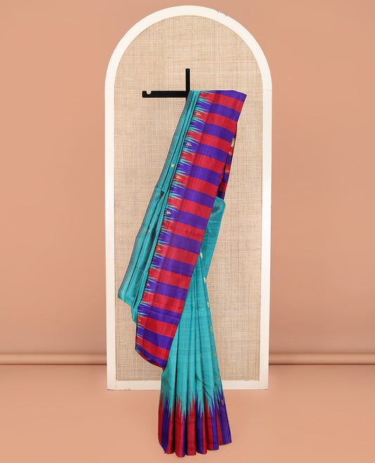 Blue Kanchipuram Silk Saree, Elevated with Zari Buttas on Its Body, Complemented by a Contrast One-Sided Thazampoo Rekku Border of Zari Buttas, Pallu Steeped with Zari Designs, and Comes Without a Blouse