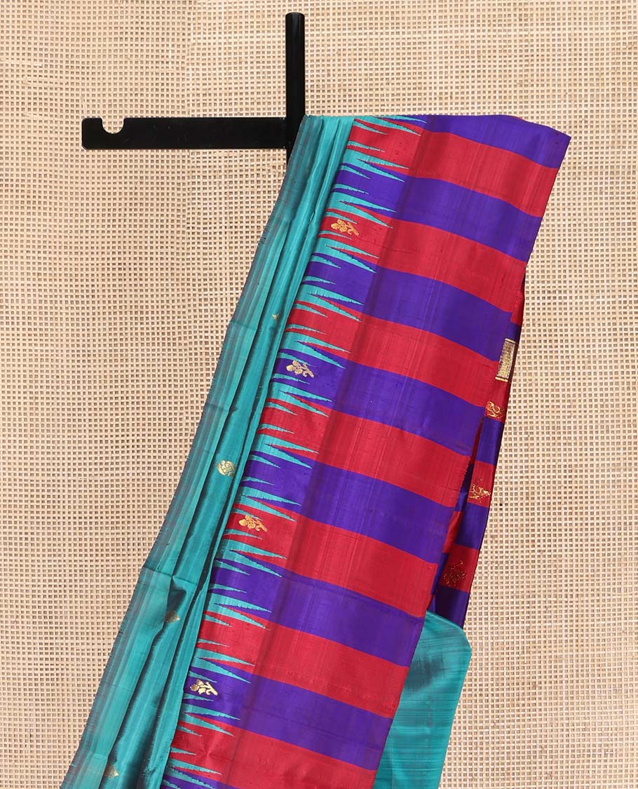 Blue Kanchipuram Silk Saree, Elevated with Zari Buttas on Its Body, Complemented by a Contrast One-Sided Thazampoo Rekku Border of Zari Buttas, Pallu Steeped with Zari Designs, and Comes Without a Blouse
