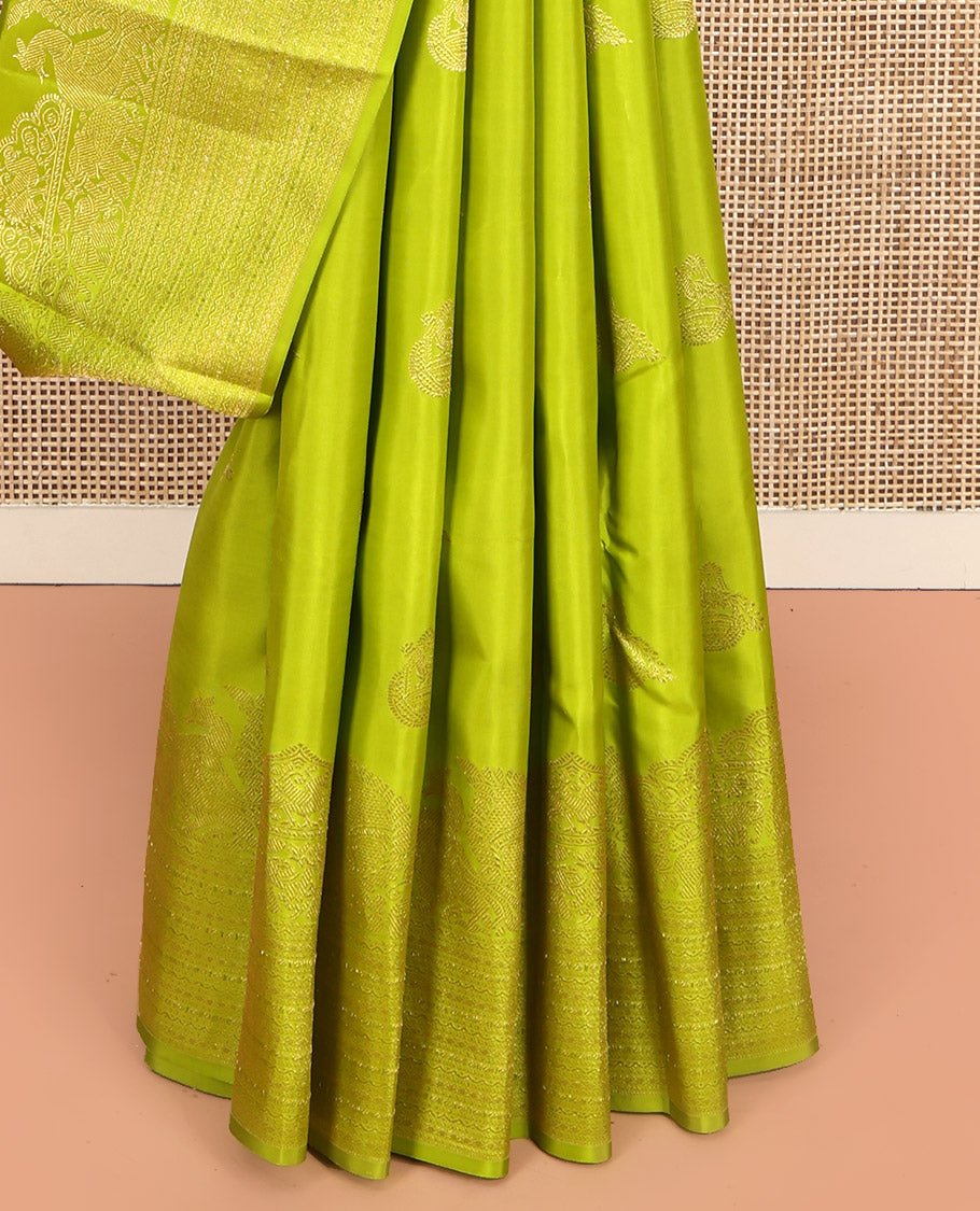 Parrot Green Kanchipuram Silk Saree, Gleamed Up with Zari Buttas All Over Its Body, Highlighted by a Zari Border of Mayil, Yaanai, and Neli Designs, Intricately Designed Pallu, and Paired with a Matching Blouse