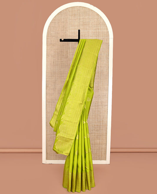 Parrot Green Kanchipuram Silk Saree, Gleamed Up with Zari Buttas All Over Its Body, Highlighted by a Zari Border of Mayil, Yaanai, and Neli Designs, Intricately Designed Pallu, and Paired with a Matching Blouse