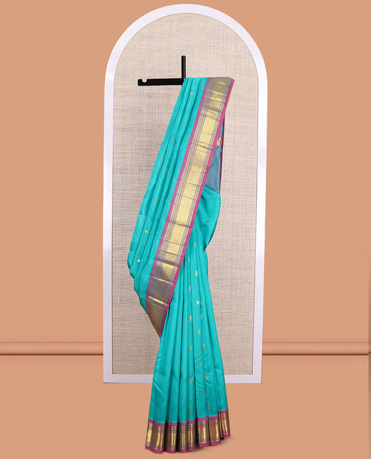 Blue Kanchipuram Silk Saree, Ornamented with Zari Buttas, a Contrast One-Sided Border of Paneer Sombu, Banaras, Muthu and Jaal Design, Zari Design Pallu, and No Blouse