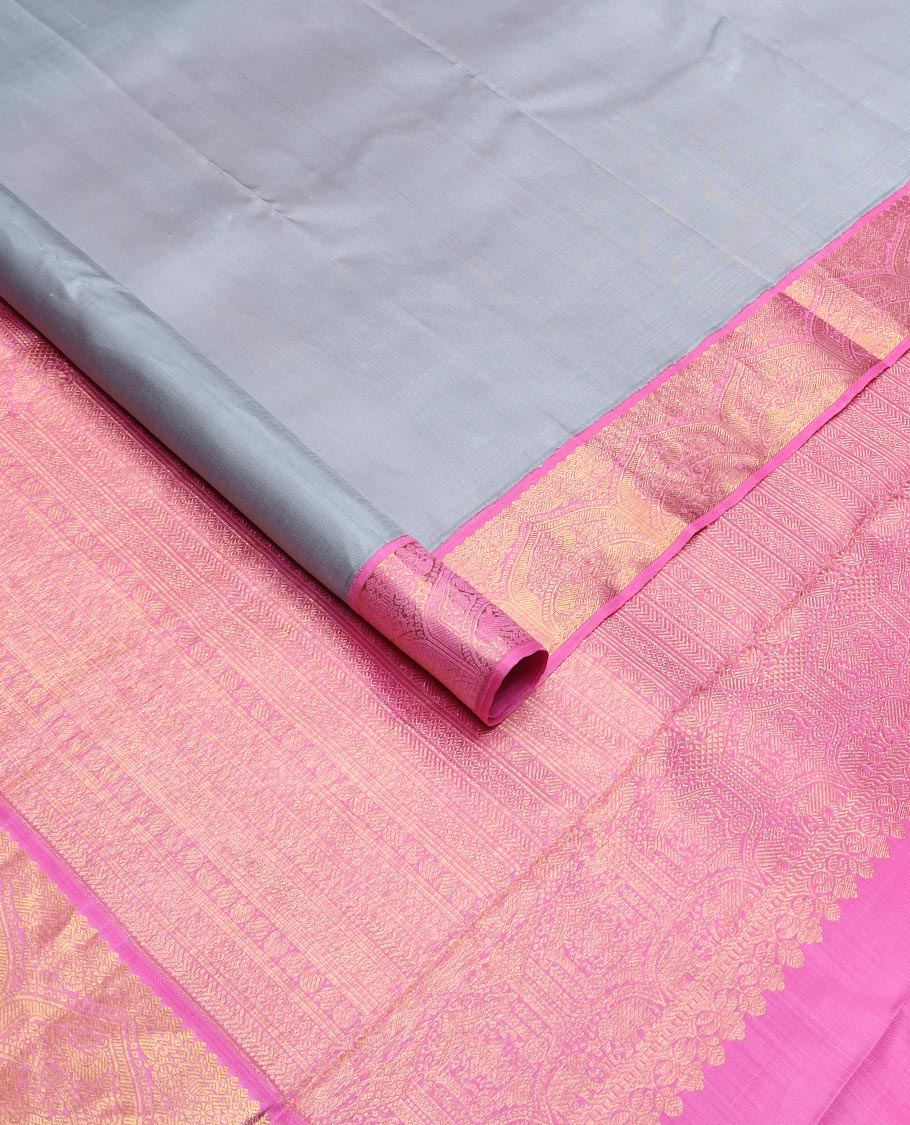 Grey plain Kanchipuram silk saree, contrast korvai zari border, and pallu steeped with traditional designs