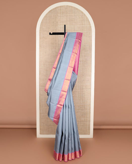 Grey plain Kanchipuram silk saree, contrast korvai zari border, and pallu steeped with traditional designs