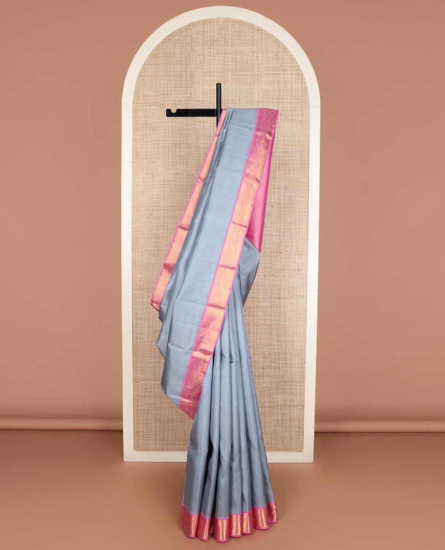 Grey plain Kanchipuram silk saree, contrast korvai zari border, and pallu steeped with traditional designs