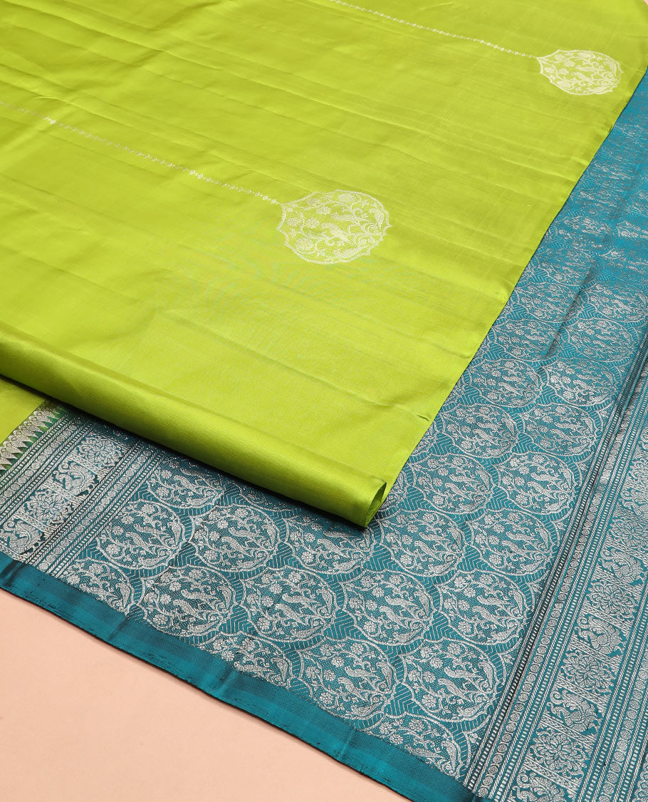 Borderless green zari buttas Kanchipuram silk saree, contrast pallu of thilakam mokku, banaras, muthu, rudraksham, annam, and floral-bird motifs
