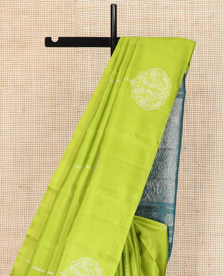 Borderless green zari buttas Kanchipuram silk saree, contrast pallu of thilakam mokku, banaras, muthu, rudraksham, annam, and floral-bird motifs