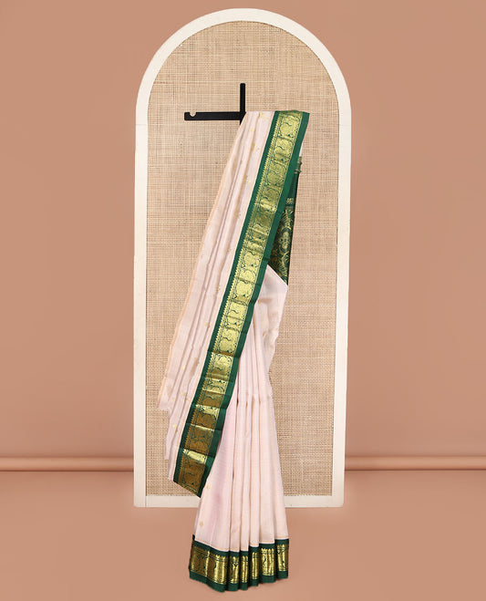 Off-White Kanchipuram Silk Saree, Embellished with Zari Buttas on Its Body, Complemented by a Contrast One-Sided Korvai Border of Salngai, Banaras, and Mayil Designs, Pallu of Floral Zari Designs, and Comes Without a Blouse