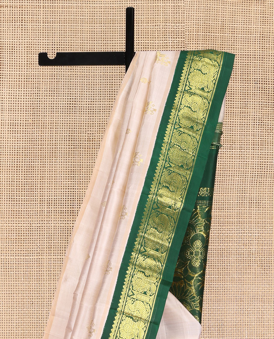 Off-White Kanchipuram Silk Saree, Embellished with Zari Buttas on Its Body, Complemented by a Contrast One-Sided Korvai Border of Salngai, Banaras, and Mayil Designs, Pallu of Floral Zari Designs, and Comes Without a Blouse