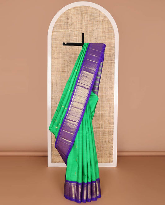 Green kancheepuram silk saree with zari buttas, contrast one-sided korvai border of salngai & mayil kann & pallu of kodi visiry & manga designs