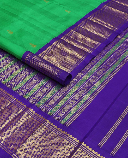 Green kancheepuram silk saree with zari buttas, contrast one-sided korvai border of salngai & mayil kann & pallu of kodi visiry & manga designs