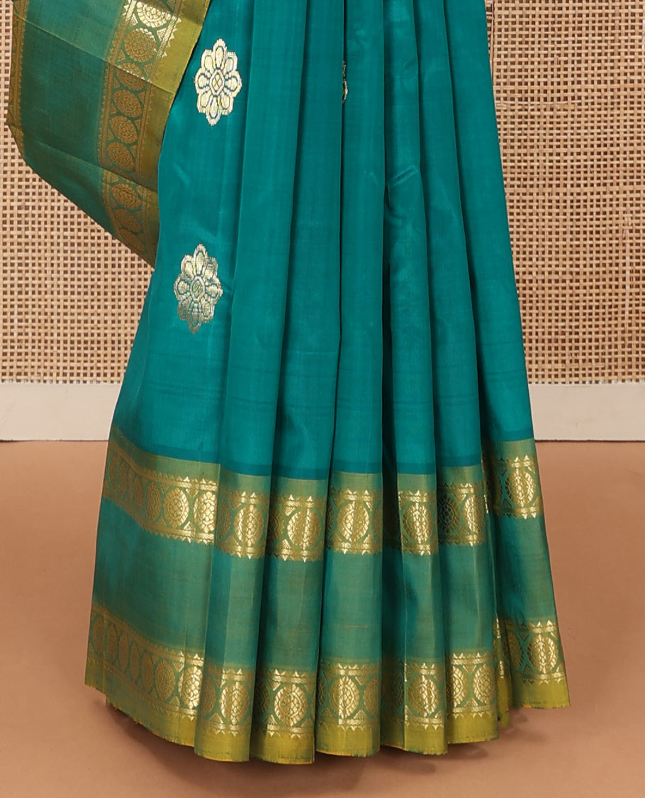 Green zari buttas Kanchipuram silk saree, contrast one-sided rettai pettu border of rekku, and laddu kamalam, and floral design pallu