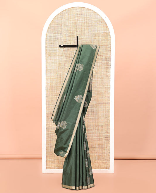 Green Mayuri Soft Silk Saree, Entralled with Zari Buttas All Over Its Body Highlighted iby Zari Piping Border, Intricately Designed Pallu and Paired with a Matching Blouse