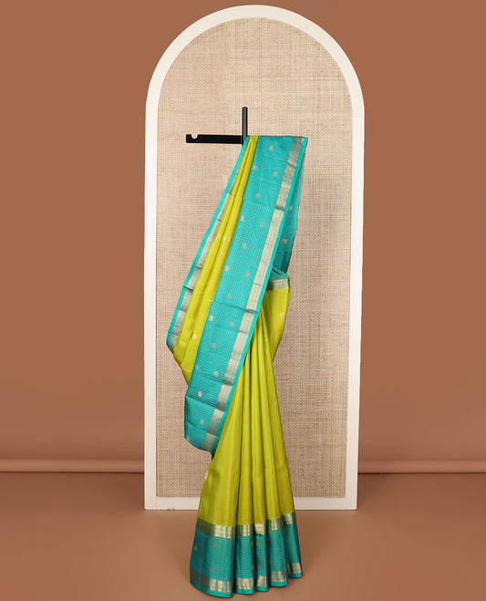 Parrot green zari buttas soft silk saree, contrast zari checked border of thilakam, banaras, mayil kann & mayil designs & geometric motifs enclosed checked pallu