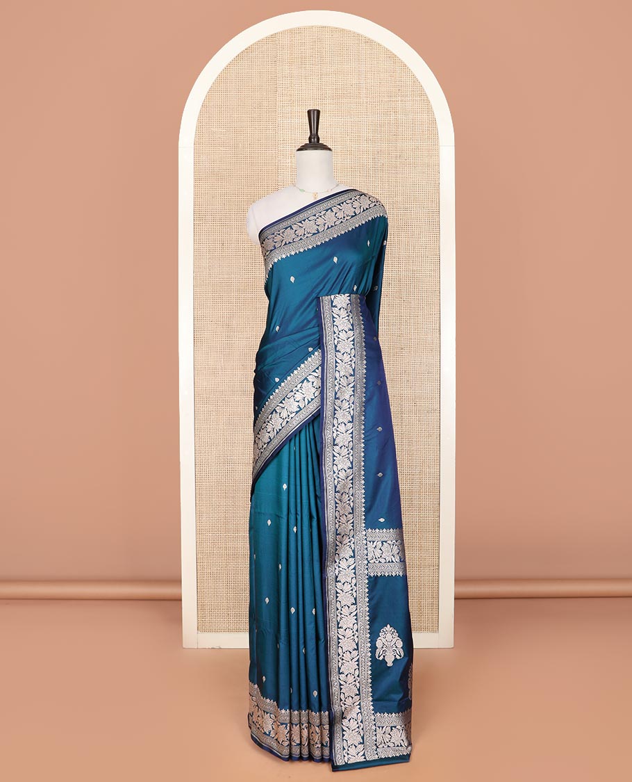 Blue zari buttas mushru silk saree, self-border of floral creeper designs, and flower vase buttas woven pallu