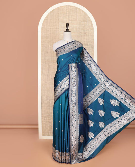 Blue zari buttas mushru silk saree, self-border of floral creeper designs, and flower vase buttas woven pallu
