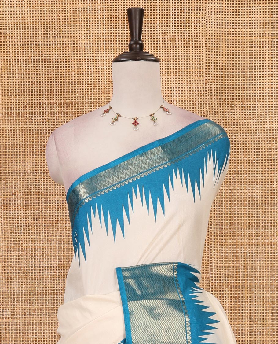 Cream-blue plain dola-tussar saree, contrast temple zari border, patola animal motifs enclosed jaal printed pallu & patola printed blouse
