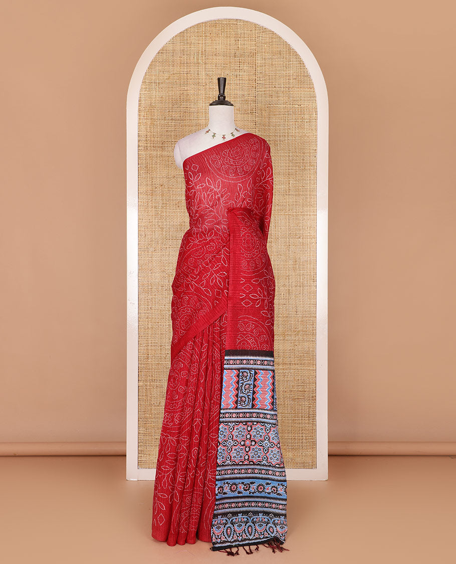 Borderless red bandhani style floral, paisley, and chakra printed semi-jute silk saree, contrast ajrakh printed pallu, and ajrakh printed blouse
