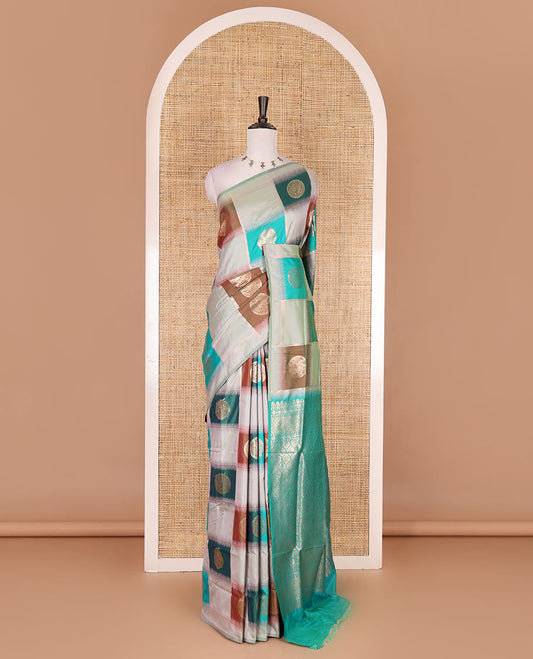 Borderless pista green chakra buttas enclosed, checked elite soft silk saree, contrast ogee patterned pallu, and contrast zari design blouse