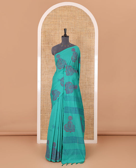 Borderless Blue kolam and kathakali motifs printed South cotton saree with a matching blouse, and a contrast floral motifs printed blouse