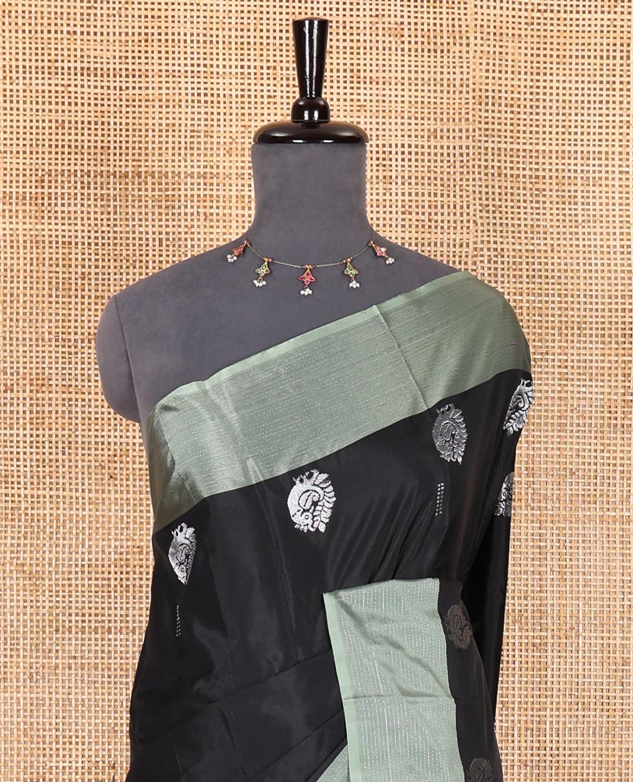 Black buttas and peacock buttas woven Kanchi silk saree, contrast satin zari striped border, zari design pallu, and a matching blouse