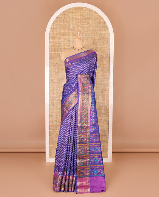 Blue chevron striped patola saree, contrast traditional zari and patola printed border, patola printed pallu, and a contrast blouse